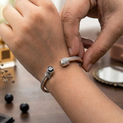 Dual-tone braided silver bracelet for women with green stone and open cuff design